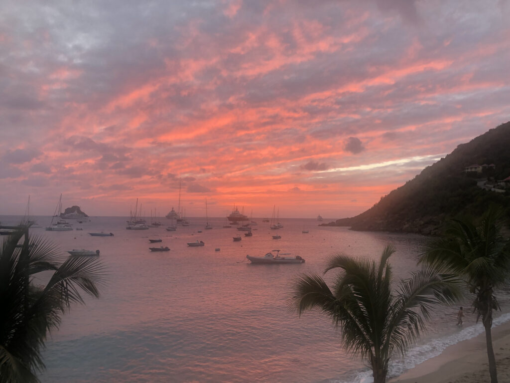 Pink sky at sunset behind Corossol hill and sea